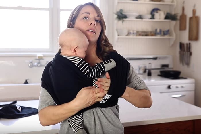 placing baby through the second loop of the baby k'tan