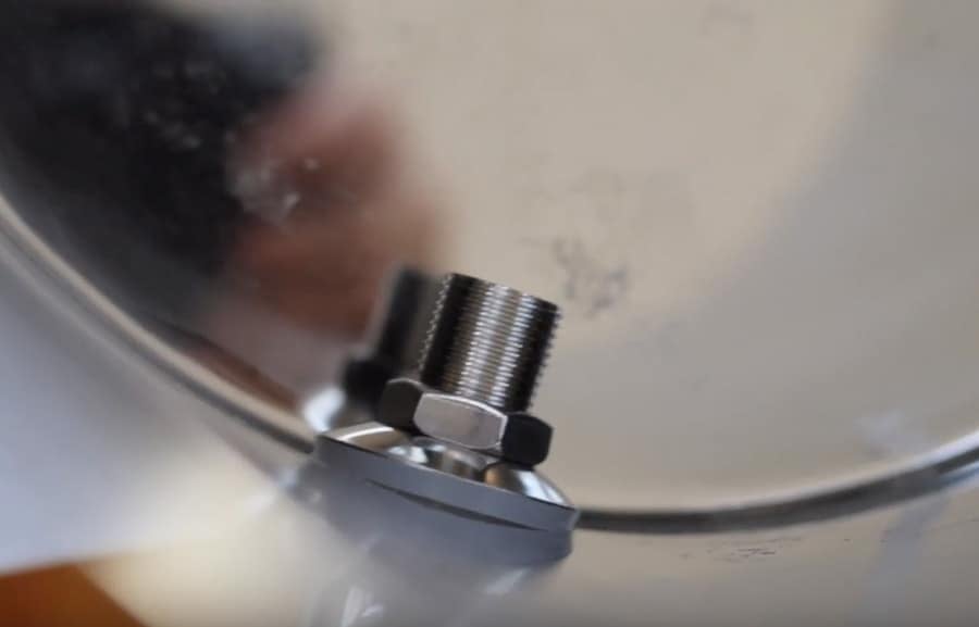 inside a Berkey water filter. Installing the stainless still spigot with metal washer, silicon gasket, and metal nut