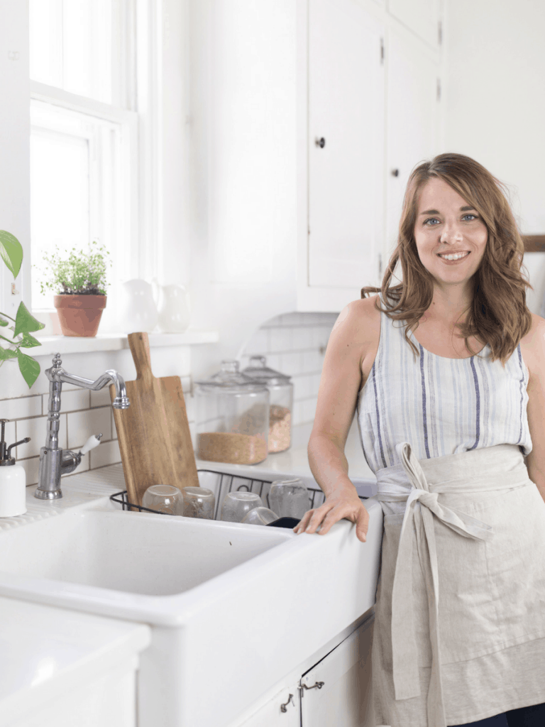 woman wearing an apron in farmhouse kitchen