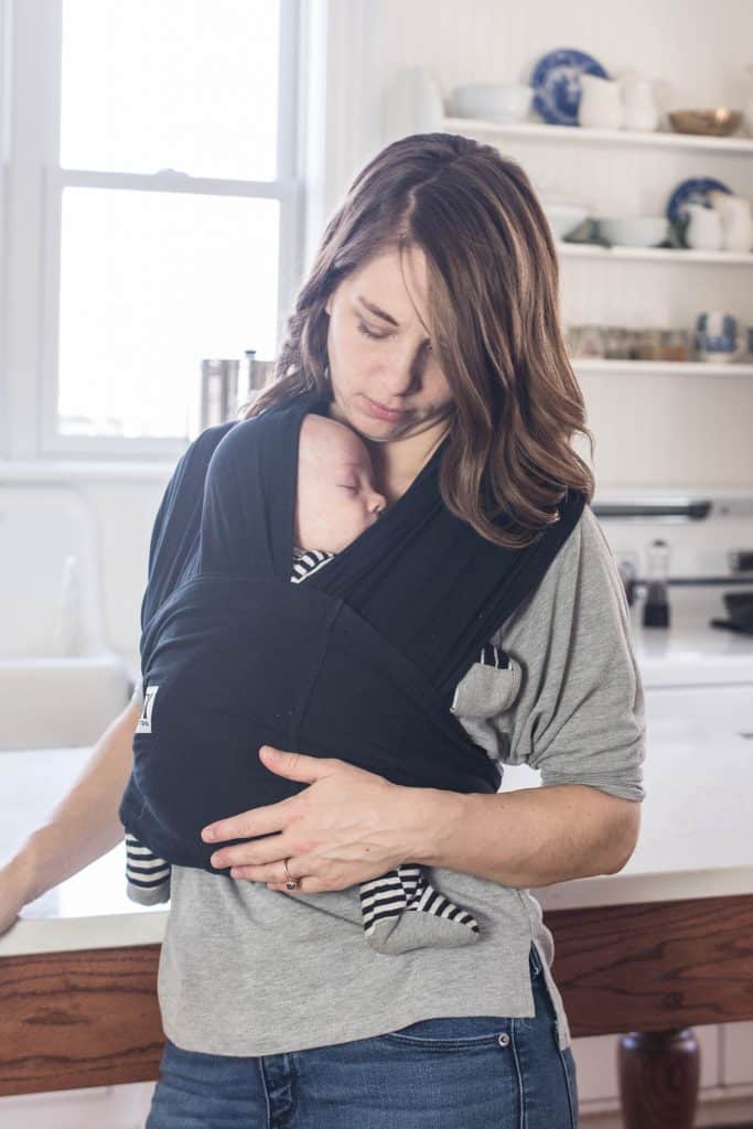 women wearing a baby k'tan wrap to compare best baby carriers
