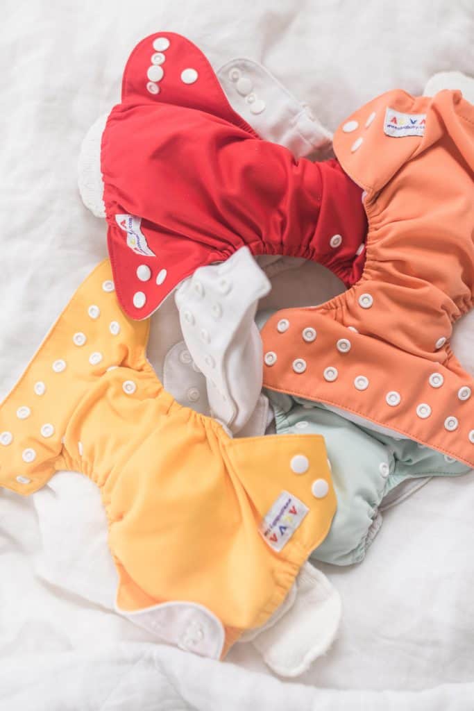 stuffed newborn pocket diapers on a blanket