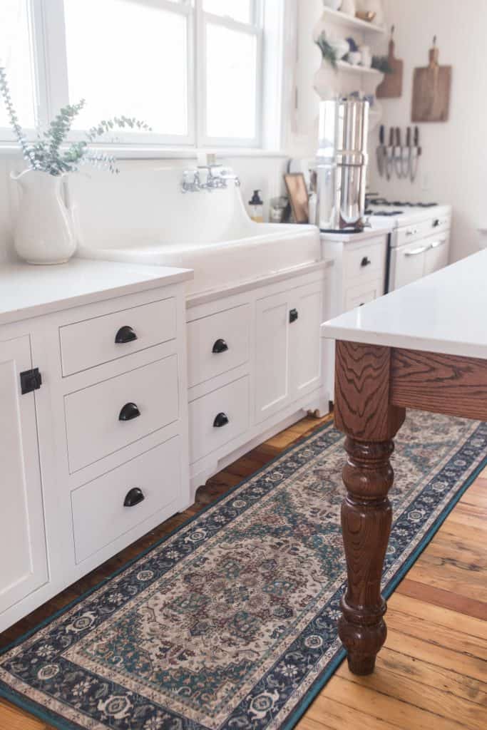 white custom cabinetry topped with white and gray quarts countertops.