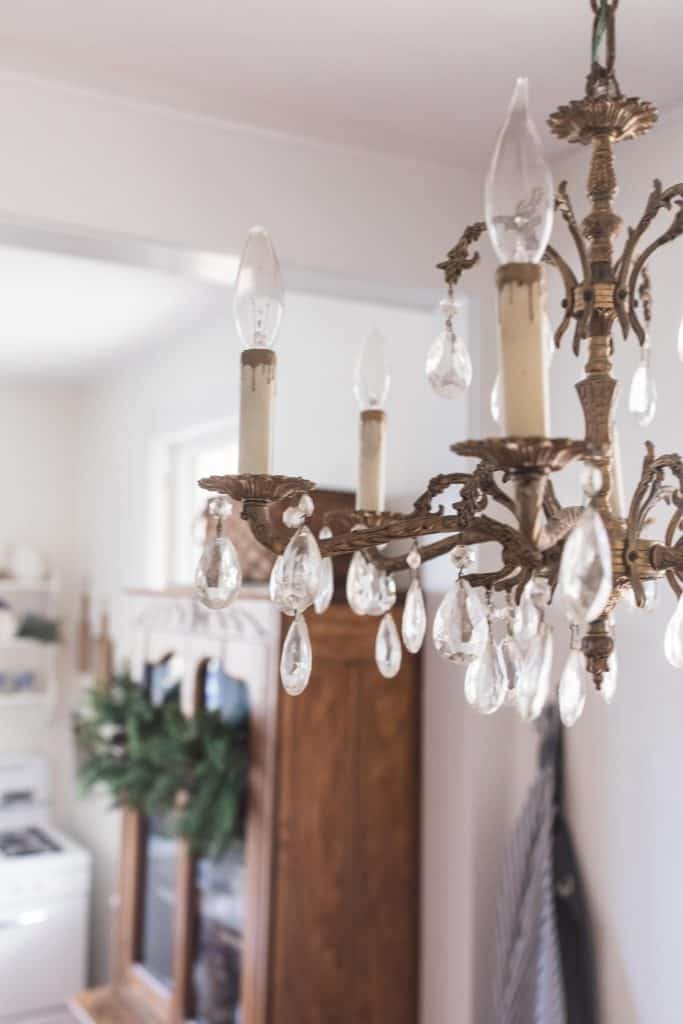 antique brass chandelier hanging in a kitchen eat-in area