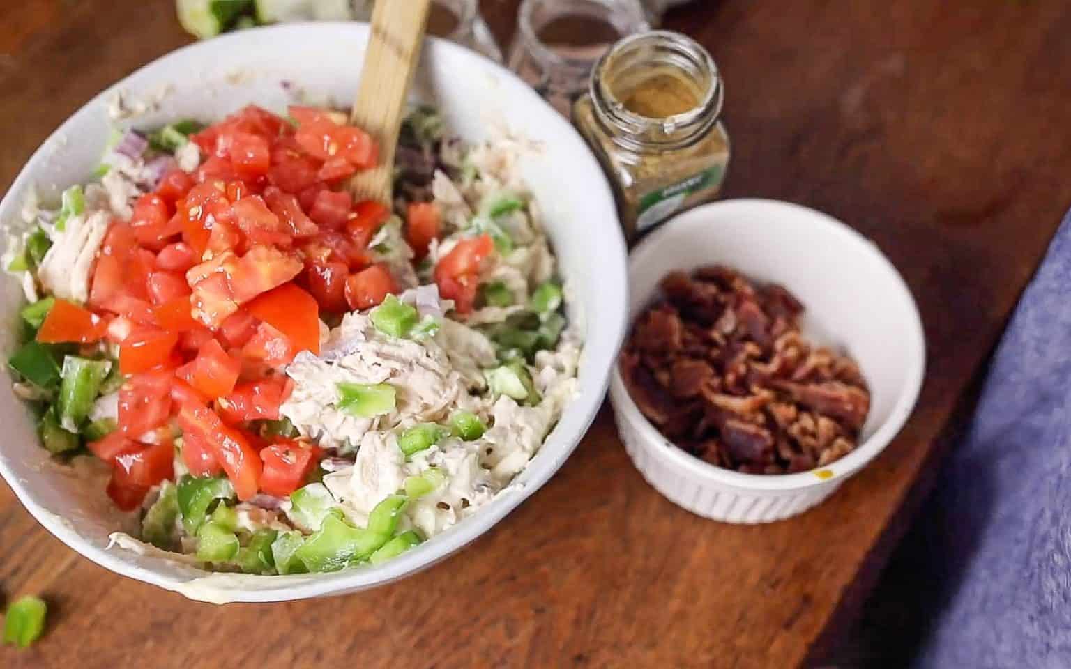 diced veggies added to a bowl.