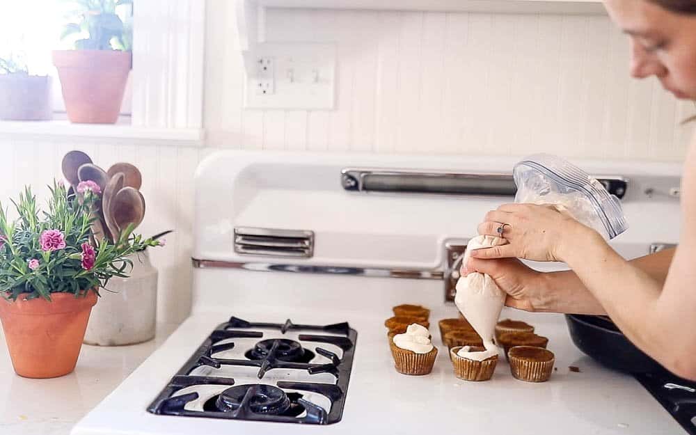 women pipping lemon whipped cream over muffins