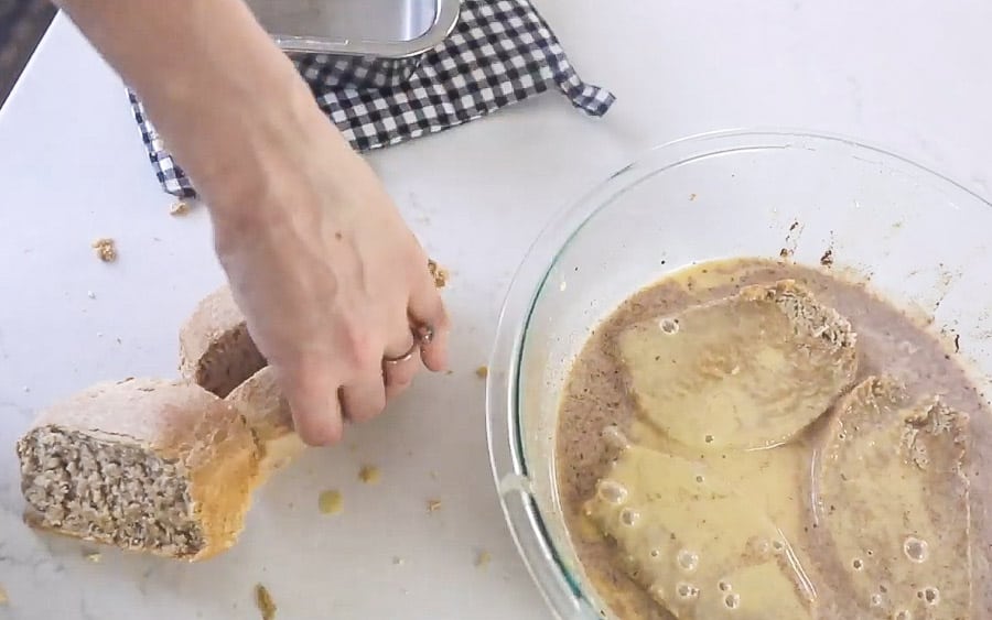 sourdough French toast soaking in egg custard mixture before frying