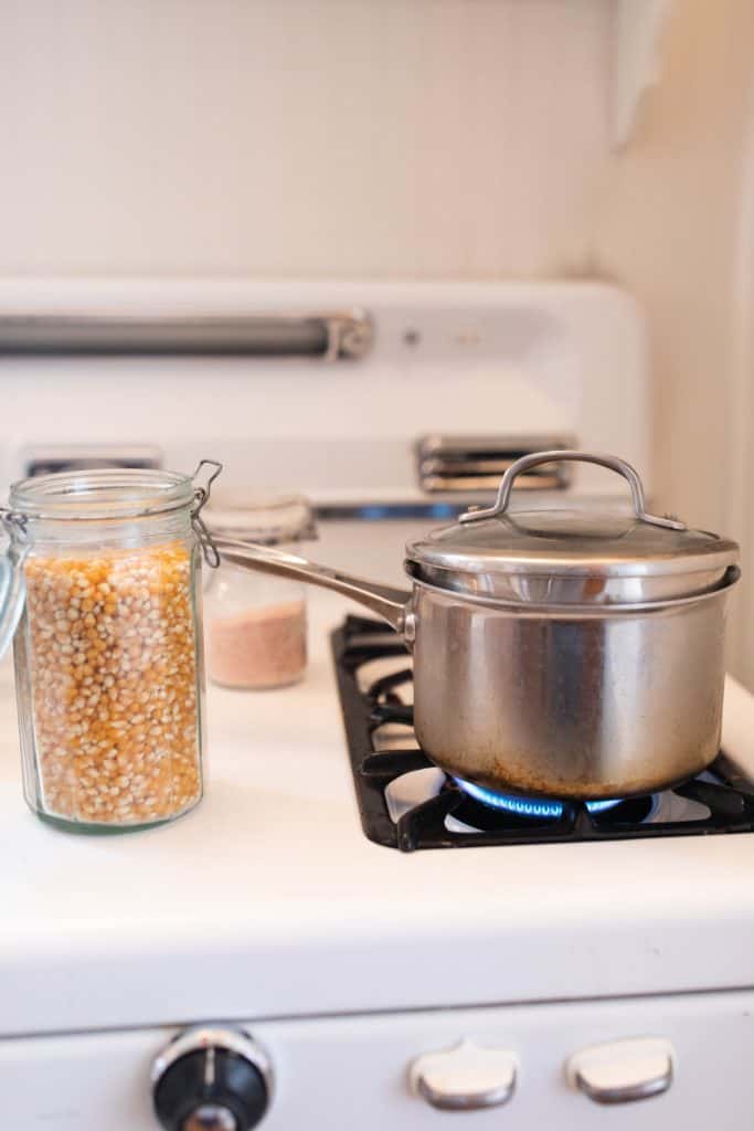 Stainless steel pot with lid over medium heat.