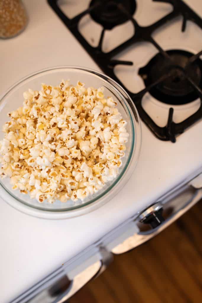 overhead shot of popcorn in a glass bowl