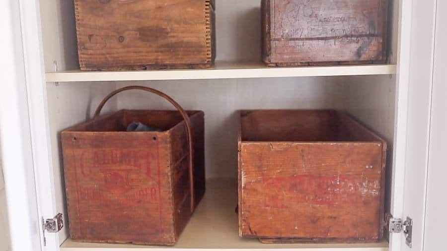 antique wooden bins for shoes in a farmhouse mud room