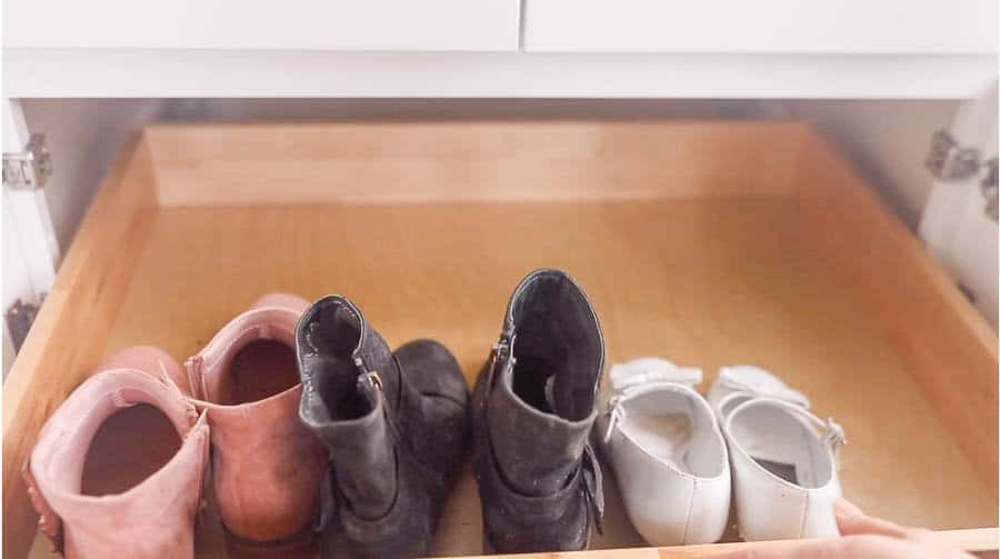 pull out drawers in a farmhouse mudroom cabinet for shoe storage