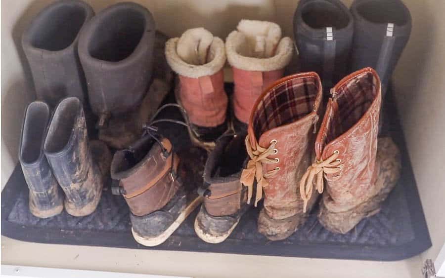 muddy winter boots on a mat