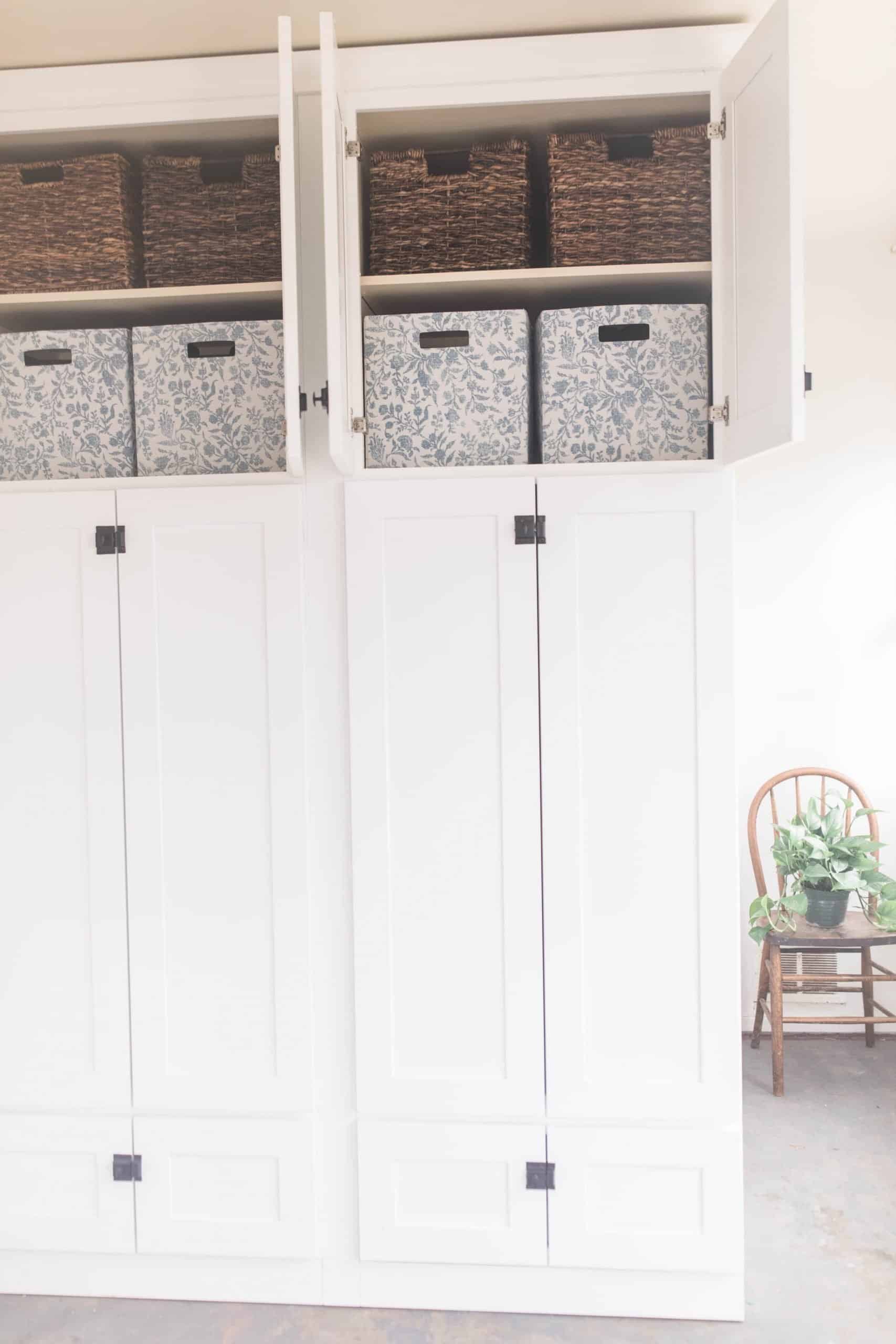 large white cabinet with black latches. Top doors are opening showing can organization