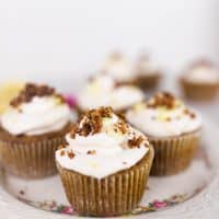 coconut flour lemon poppy seed muffins topped with whipped cream, toasted coconut and pink flowers