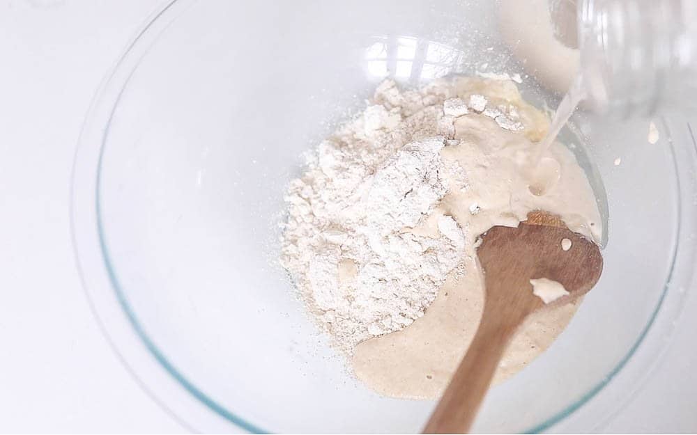 flour, coconut oil, and sourdough starter in a glass bowl