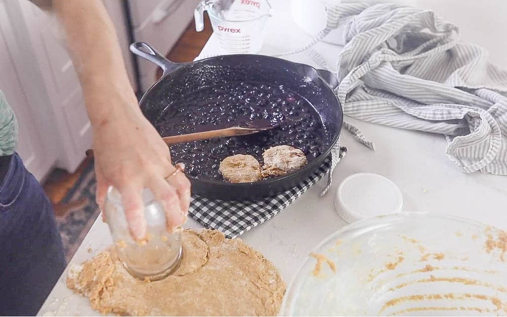 cutting and adding sourdough biscuits to blueberries