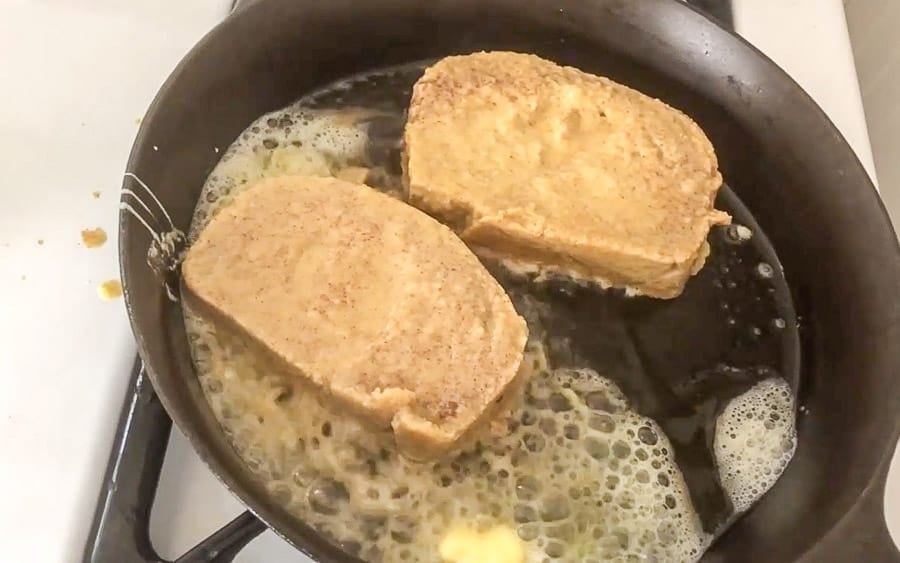 sourdough French toast frying in a skillet