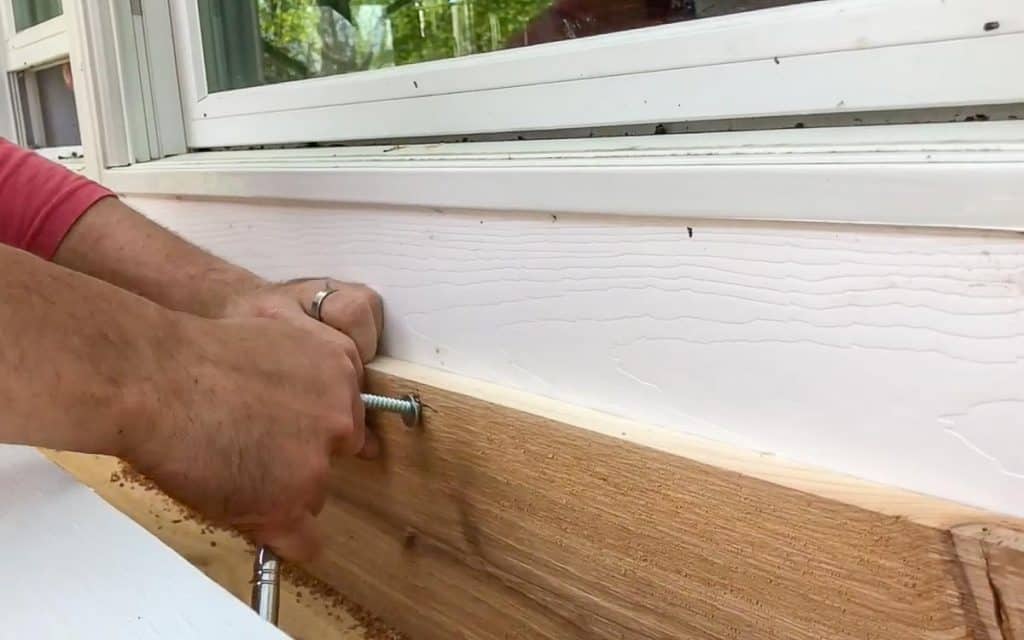 hanging a DIY window box using lag bolds and a wrench