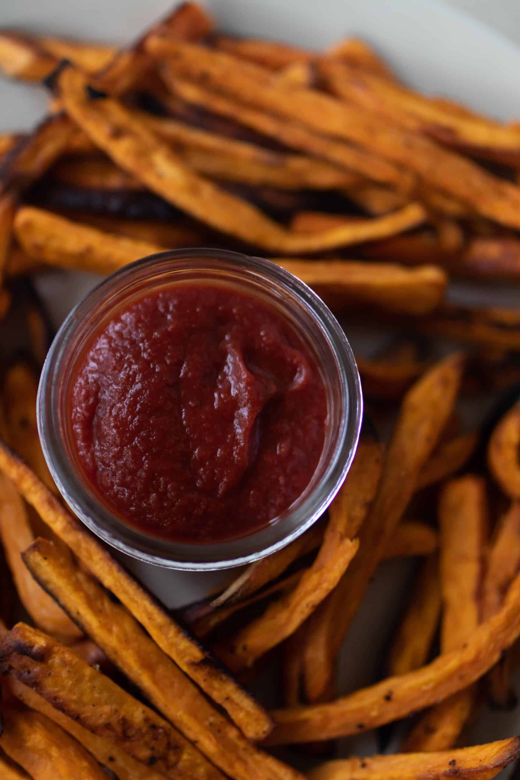 close up overhead photo of fermented ketchup in the middle of sweet potato fries