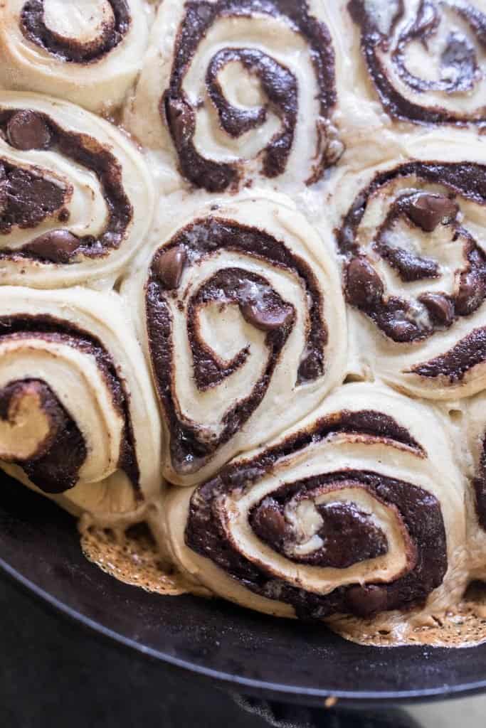 close up picture of sourdough rolls with gooey chocolate swirled into the dough and baked in a cast iron skillet