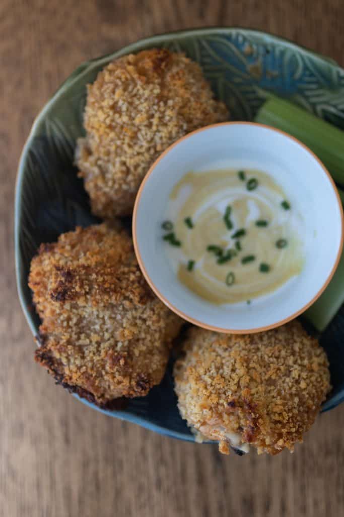 sourdough fried chicken in tin bowl with dip in the middle