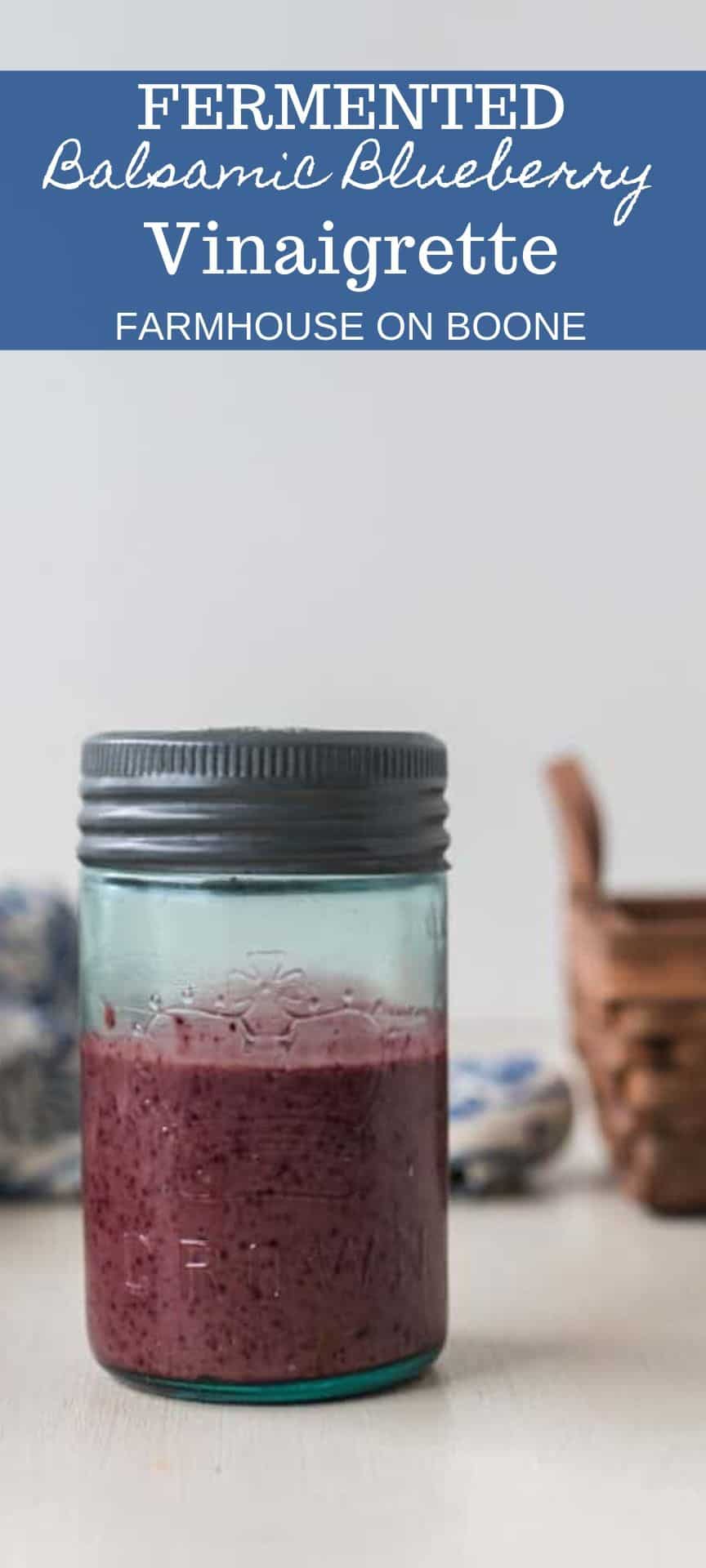 balsamic blueberry dressing in a glass jar with a basket in the background