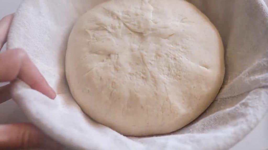 artisan sourdough bread dough in a banneton bowl