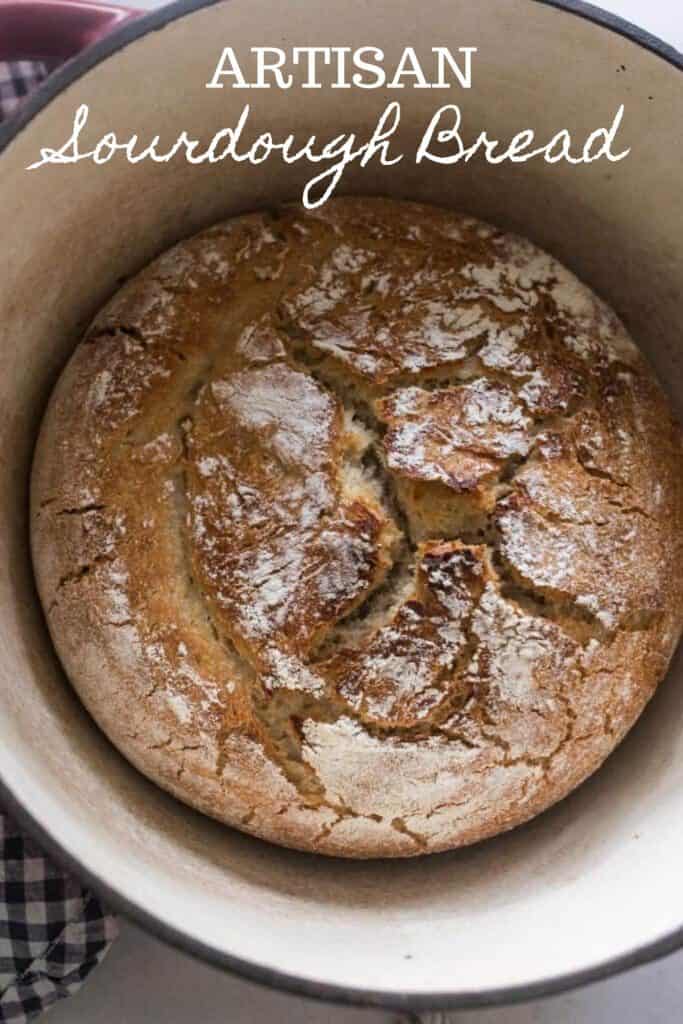 overhead photo of homemade artisan sourdough bread in a dutch oven