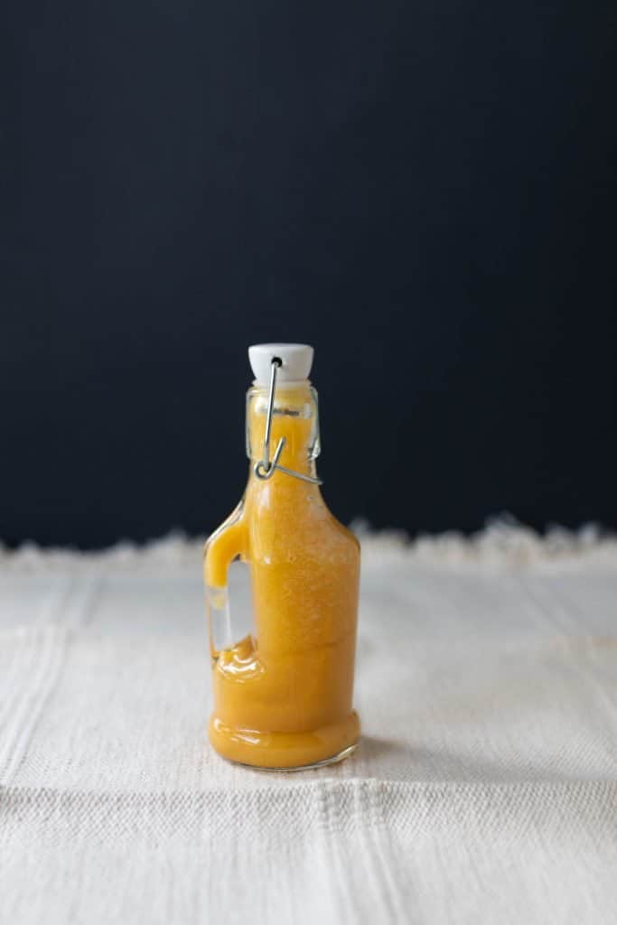 fermented hot sauce in a glass bottle with a swing top lid