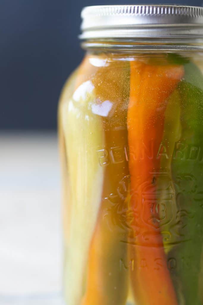 close up picture of fermented peppers in a jar to make fermented hot sauce