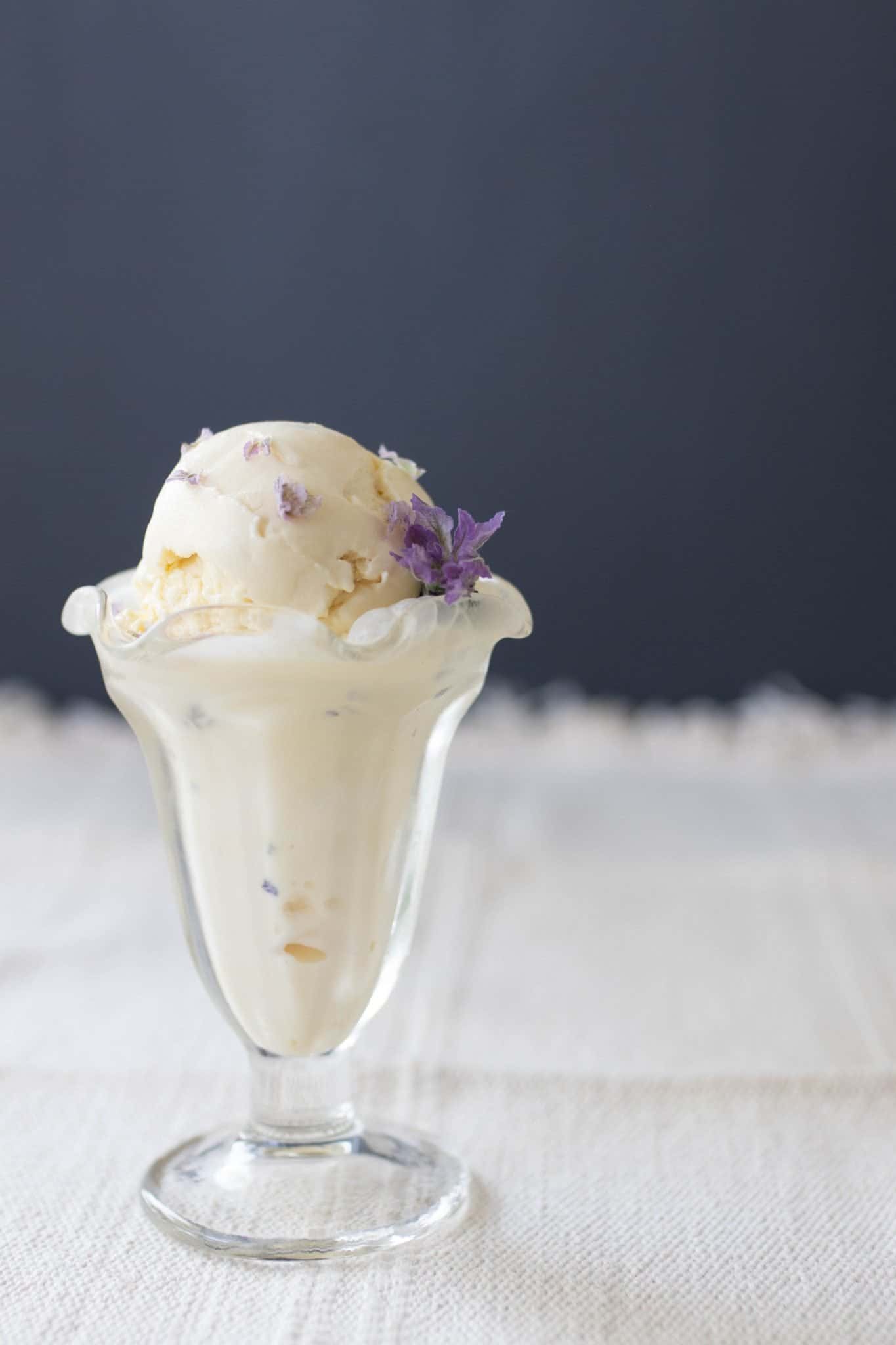 Lavender ice cream in a glass Sunday cup with a lavender flower in the ice cream.