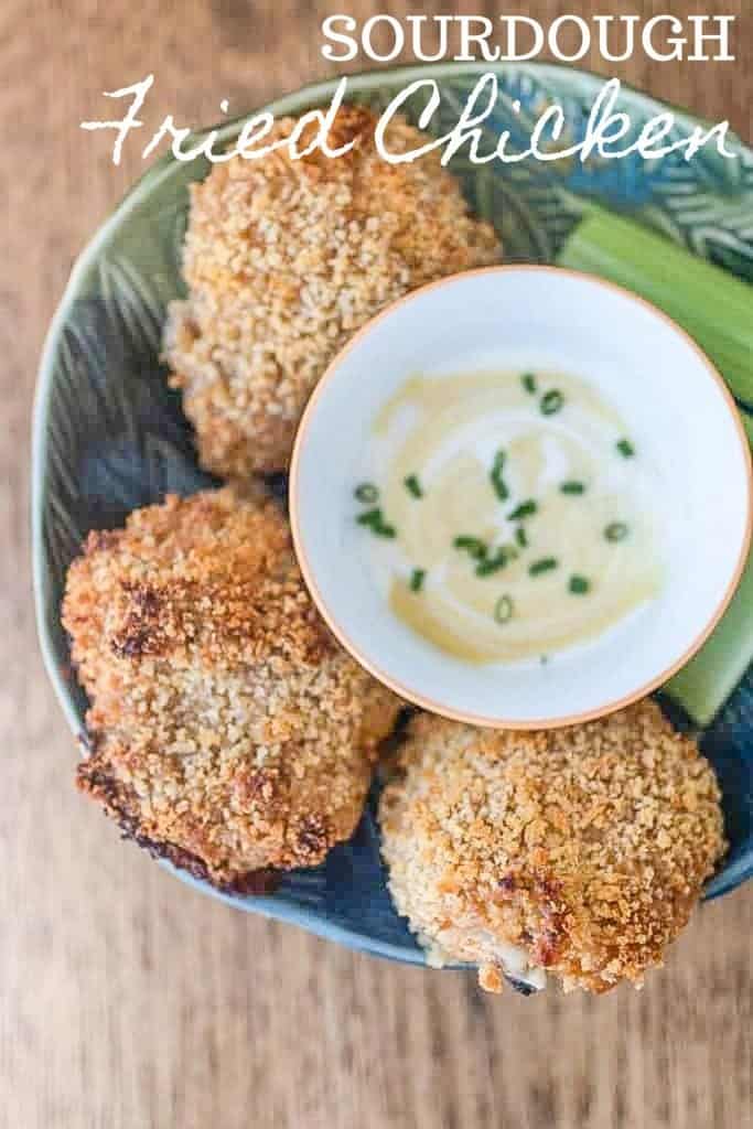 sourdough fried chicken in tin bowl with dip in the middle