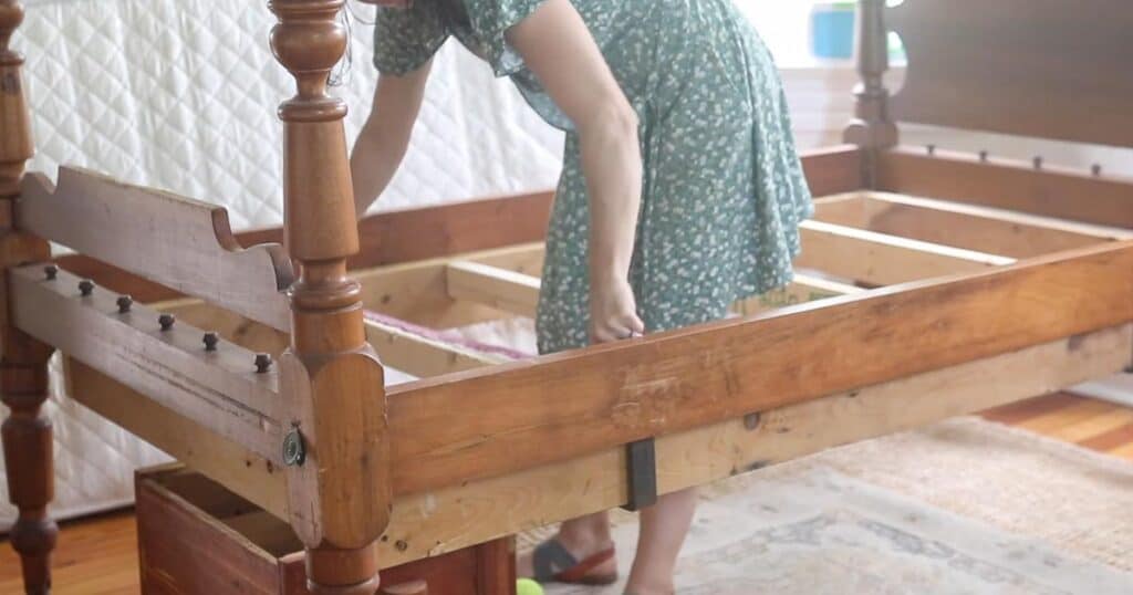 women measuring bed frame