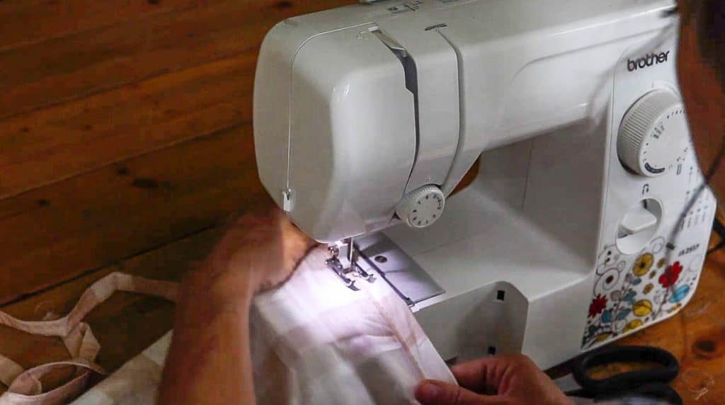 hem being sew into fabric to create curtains