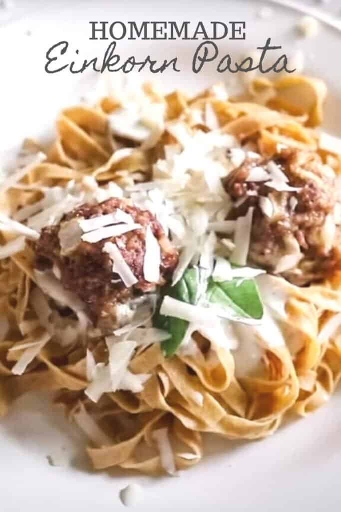 einkorn pasta with meatballs topped with cheese and basil