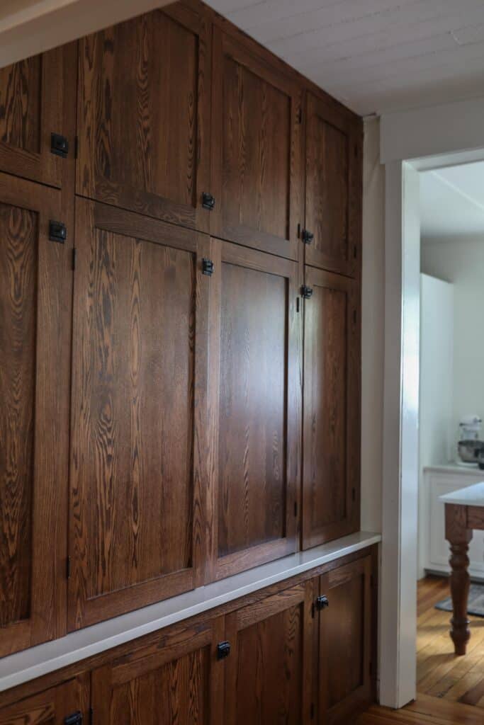 side view of antique looking floor to ceiling cabinets to create an office nook