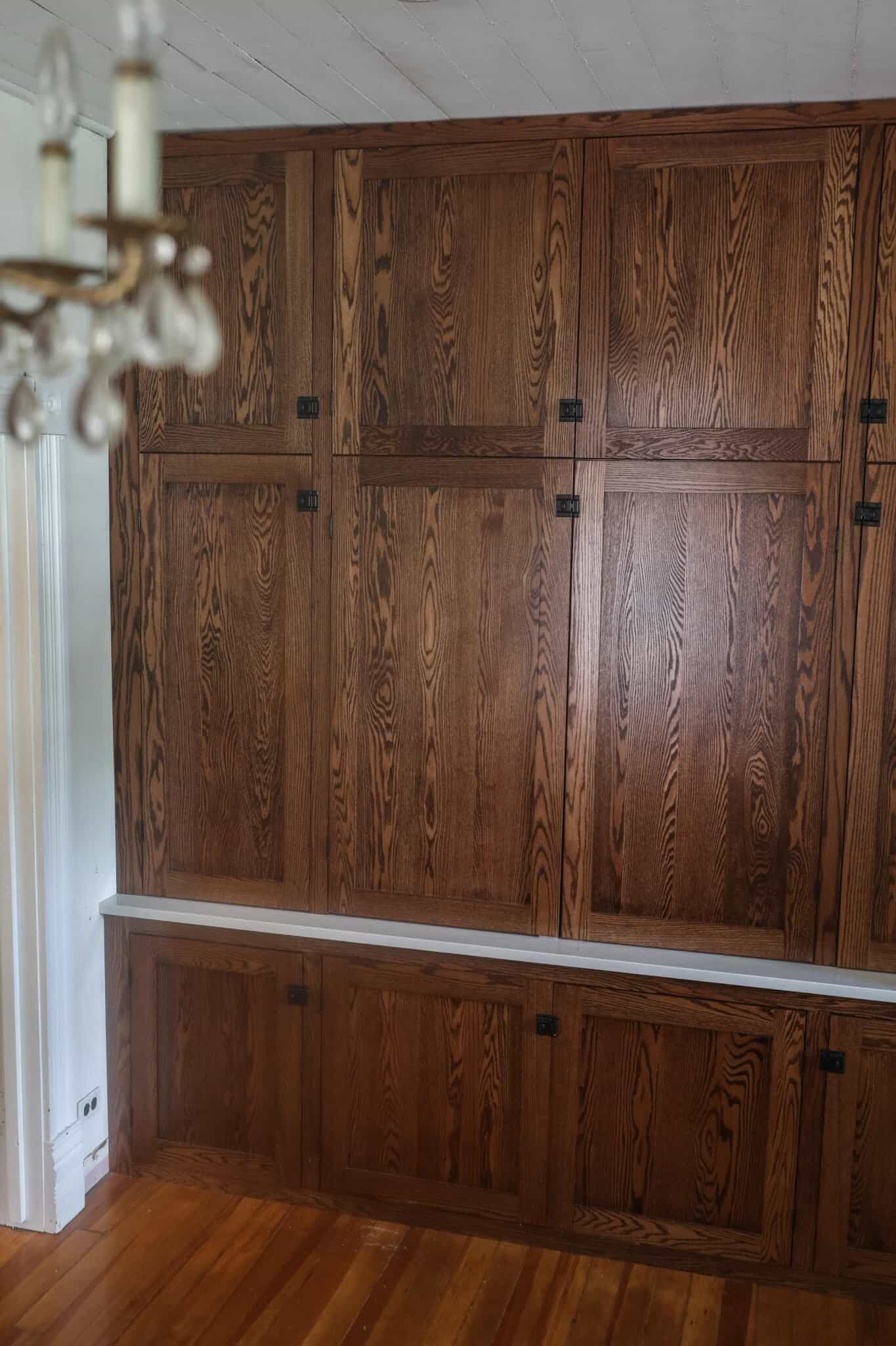 side view of a built in office nook made with antique inspired wood cabinetry and quartz countertops