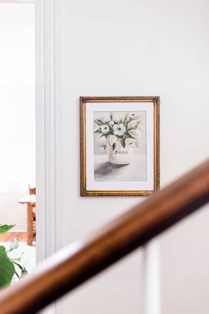 farmhouse floral print in a gold frame on a white wall