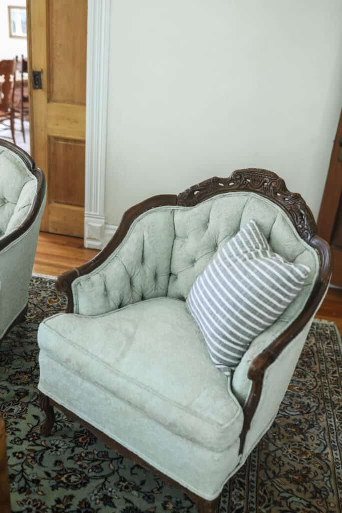 victorian love seat with a stripped pillow