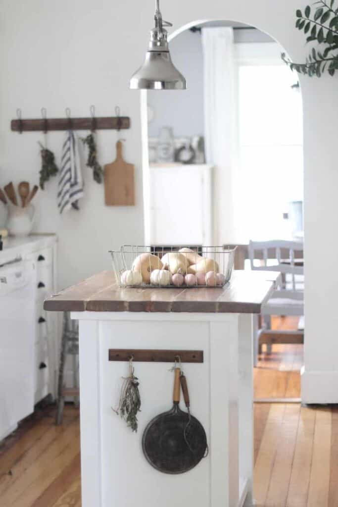 apron and cutting boards hanging on a kitchen wall