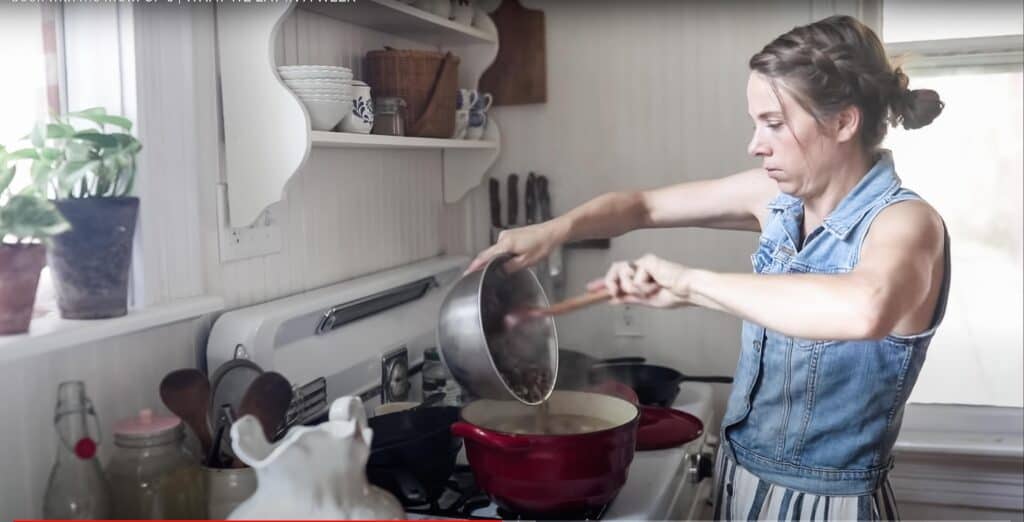 women cooking soup on an antique stove.