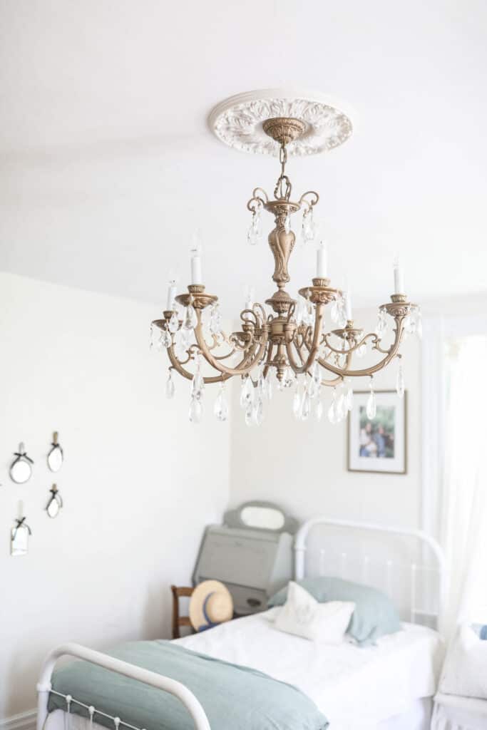 gold victorian chandelier with crystals hands in a girls room