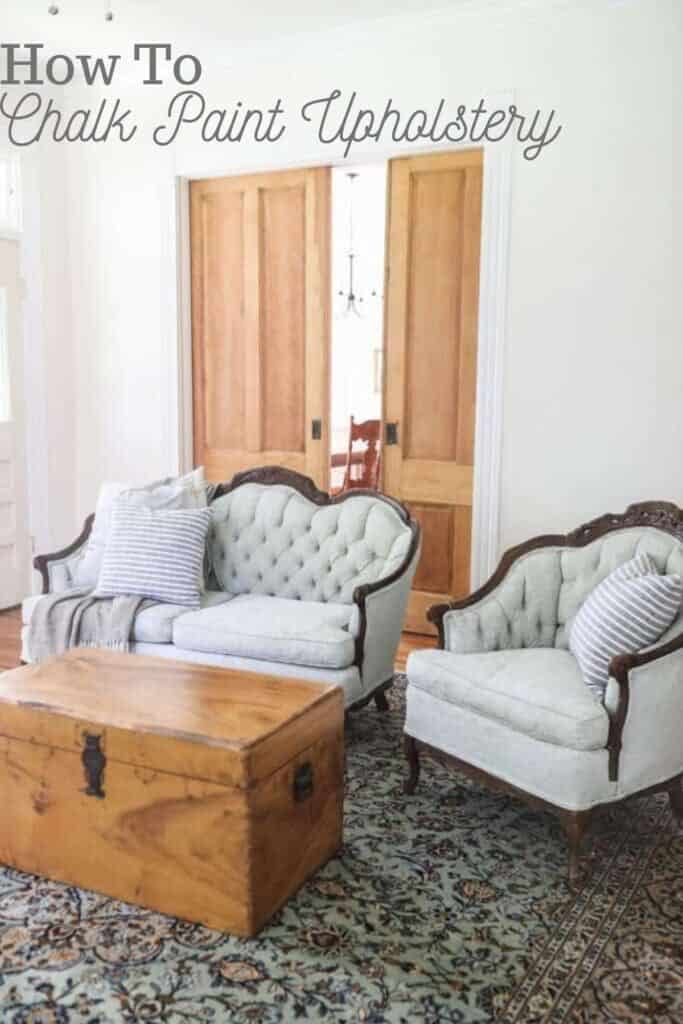 victorian couches painted a soft green in a living room with a wood chest as a coffee table