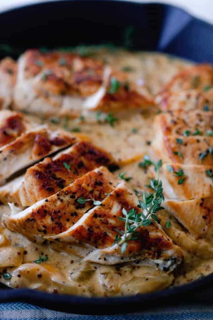 sliced chicken breasts over a creamy white wine peach sauce