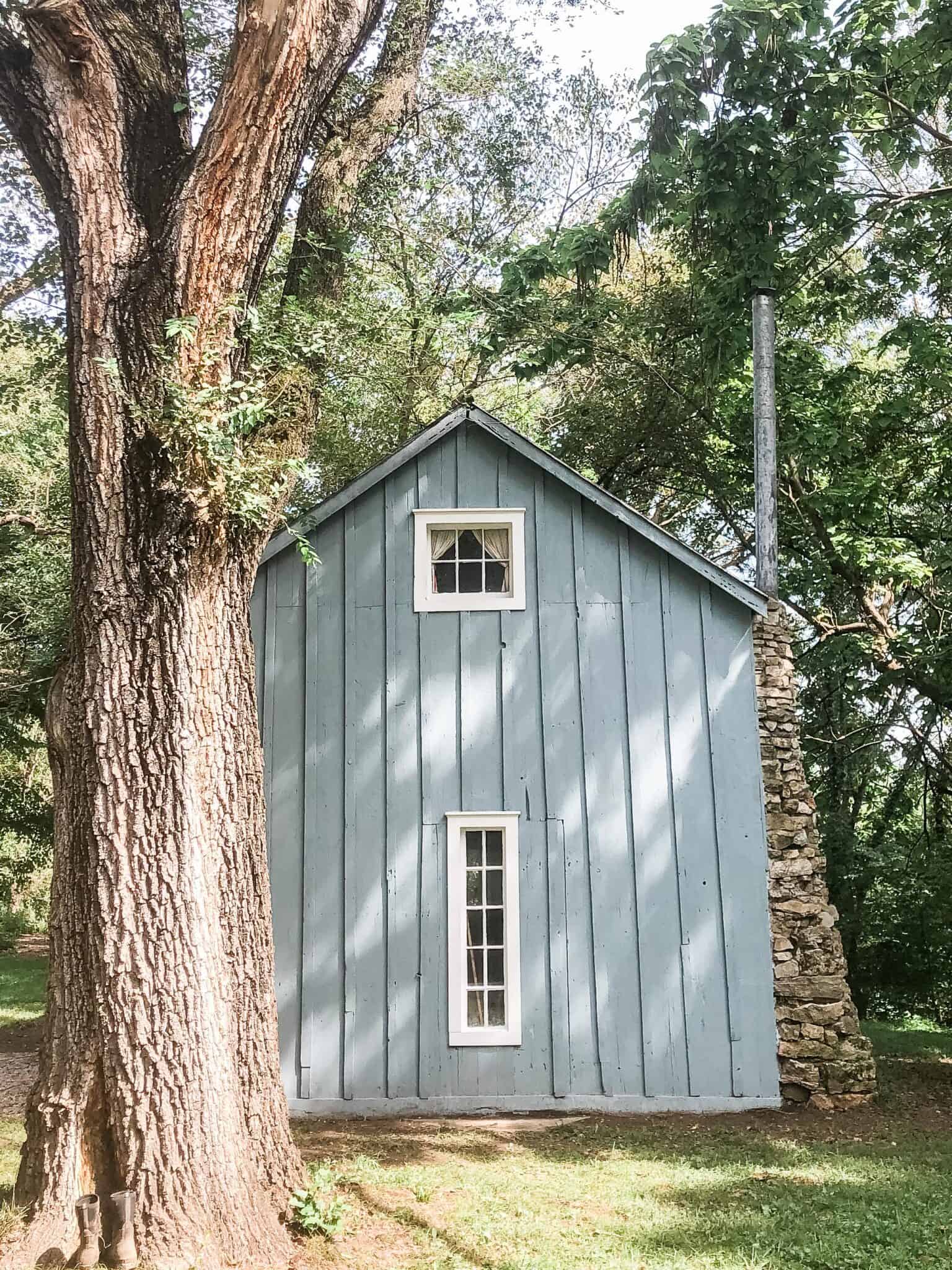 little blue cottage with white farmhouse trim