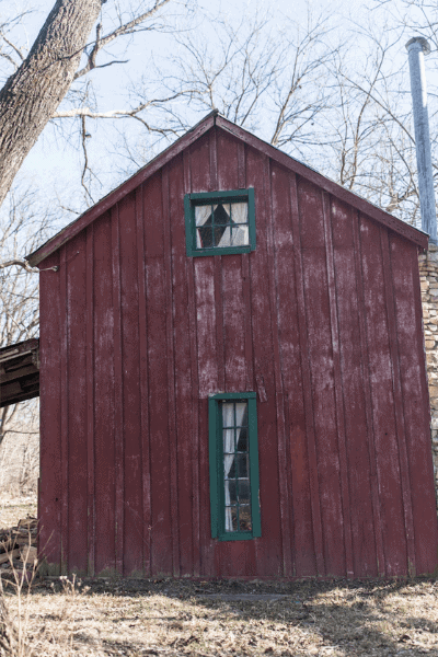 red cottage before new trim and paint