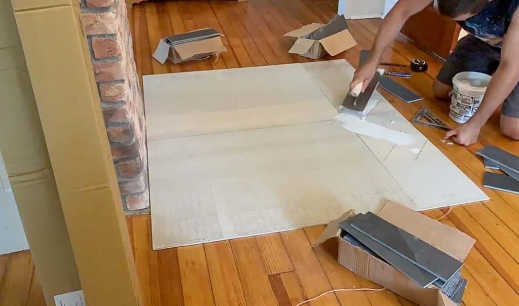 adding thinset tile adhesive to backer board to lay tile