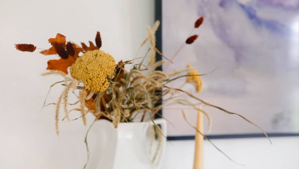 variety of dried fall florals in a white ironstone pitcher
