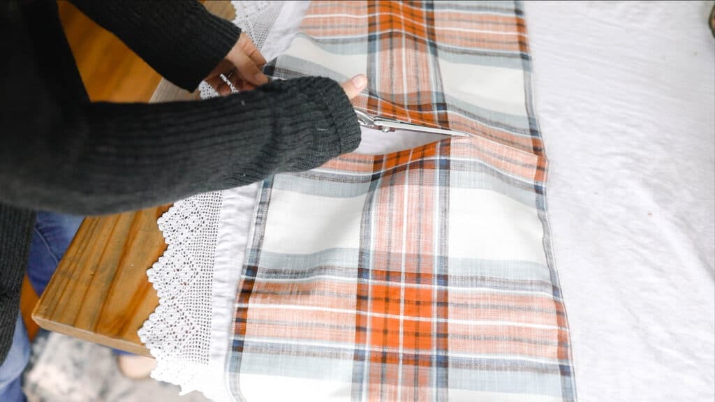 cutting a table runner to create a fall inspired pillow