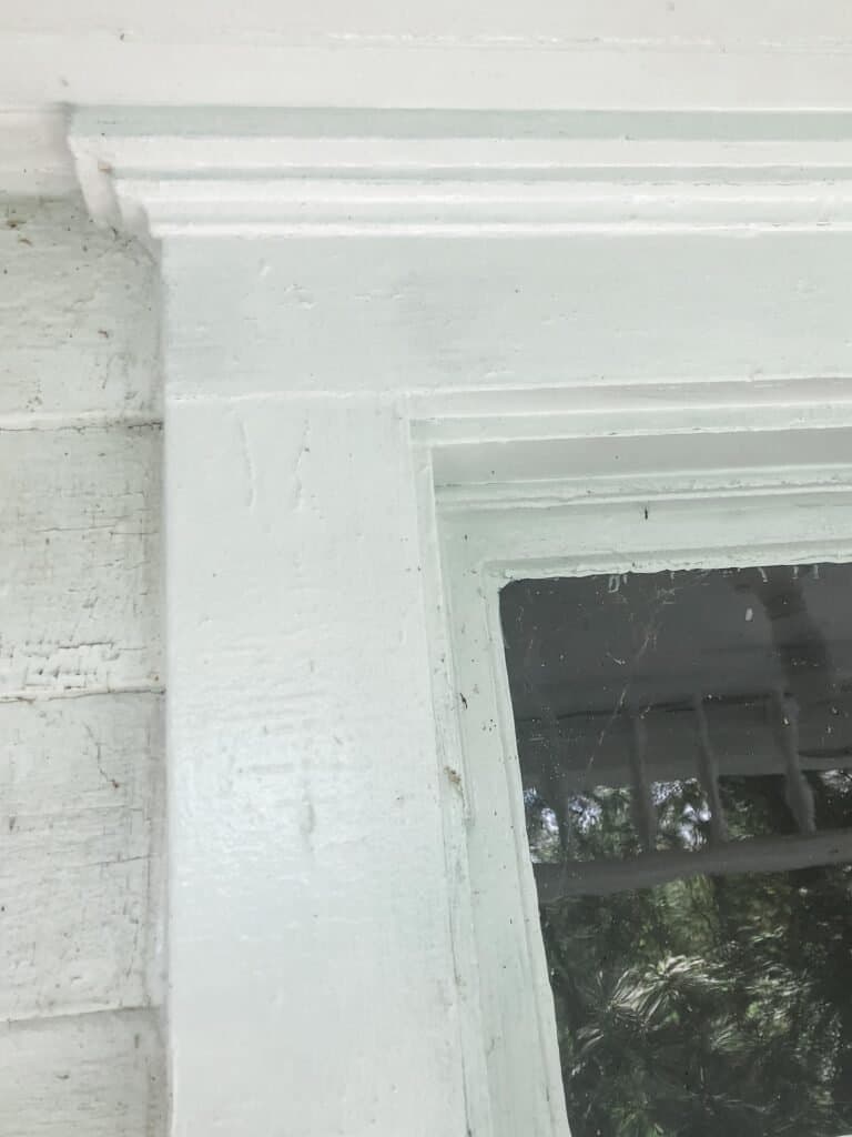white farmhouse window trim on an old farmhouse