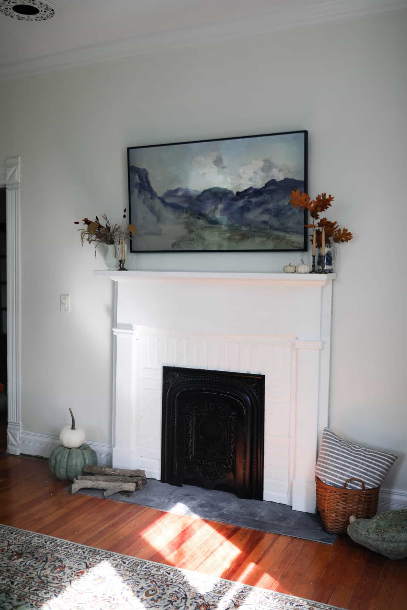 white DIY faux fireplace with white brick and a vintage mantle